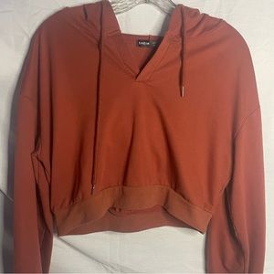 Burnt orange cropped sweatshirt.